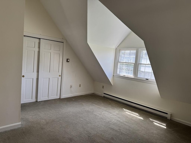 additional living space featuring carpet flooring, baseboards, baseboard heating, and lofted ceiling