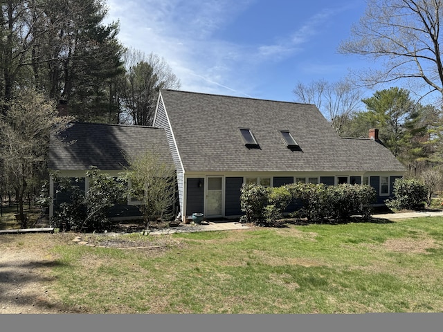 cape cod home with a front lawn, roof with shingles, and a chimney
