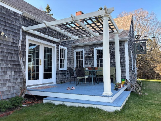 exterior space with a pergola, outdoor dining area, and a yard