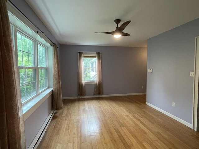 45 Seaview Ter, Belfast, ME 04915 - empty room with a baseboard radiator, light wood finished floors, and ceiling fan