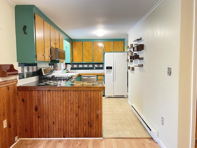 45 Seaview Ter, Belfast, ME 04915 - kitchen featuring stainless steel appliances, baseboard heating, a peninsula, light floors, and crown molding