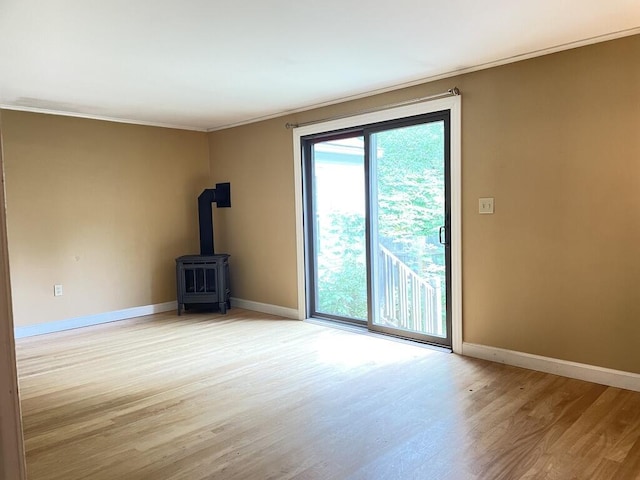 45 Seaview Ter, Belfast, ME 04915 - unfurnished living room with a wood stove, ornamental molding, and light wood finished floors