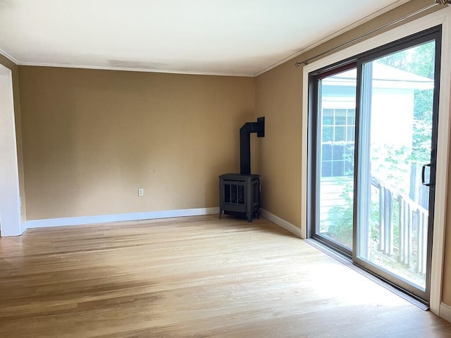 45 Seaview Ter, Belfast, ME 04915 - unfurnished living room with ornamental molding, plenty of natural light, light wood-style floors, and a wood stove