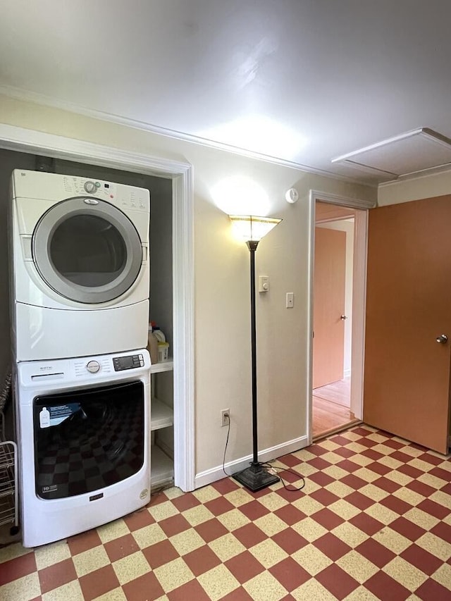 45 Seaview Ter, Belfast, ME 04915 - laundry area featuring stacked washer and clothes dryer, light flooring, and crown molding