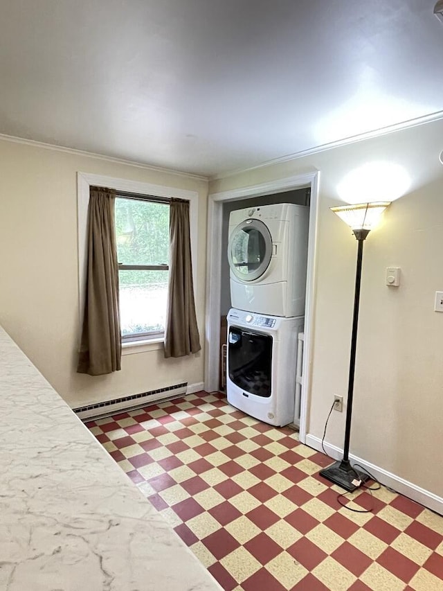 45 Seaview Ter, Belfast, ME 04915 - washroom with a baseboard heating unit, estacked washer and dryer, light flooring, and crown molding