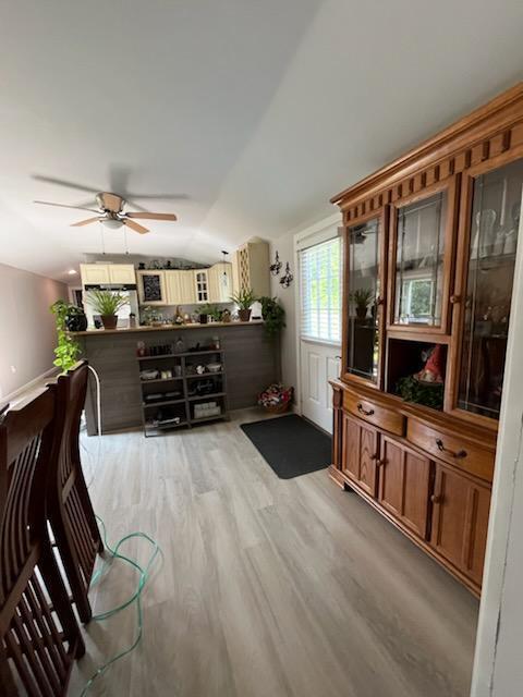 924 Great Pond Rd, Great Pond, ME 04408 - living area with lofted ceiling, light wood-type flooring, and a ceiling fan