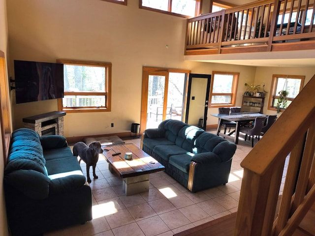 29 Punkin Hill Rd, South Thomaston, ME 04858 - living area with tile patterned flooring, a towering ceiling, plenty of natural light, and a fireplace
