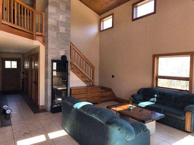 29 Punkin Hill Rd, South Thomaston, ME 04858 - living area with high vaulted ceiling, tile patterned flooring, stairway, plenty of natural light, and wood ceiling