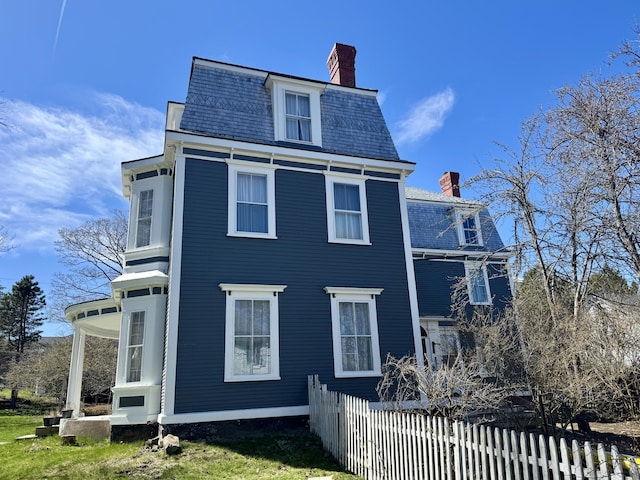 17 Boynton St, Eastport, ME 04631 - view of front of house with a chimney, a high end roof, and mansard roof