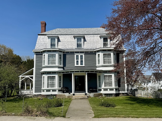 17 Boynton St, Eastport, ME 04631 - victorian home featuring a porch and a chimney