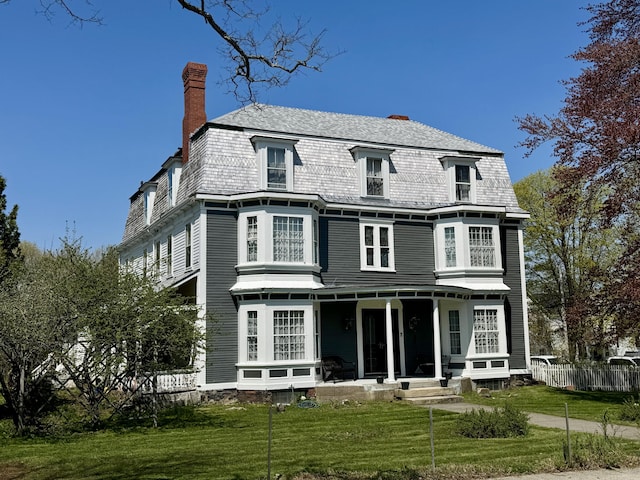 17 Boynton St, Eastport, ME 04631 - back of house with a chimney and covered porch