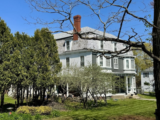 17 Boynton St, Eastport, ME 04631 - rear view of property featuring a lawn and a chimney