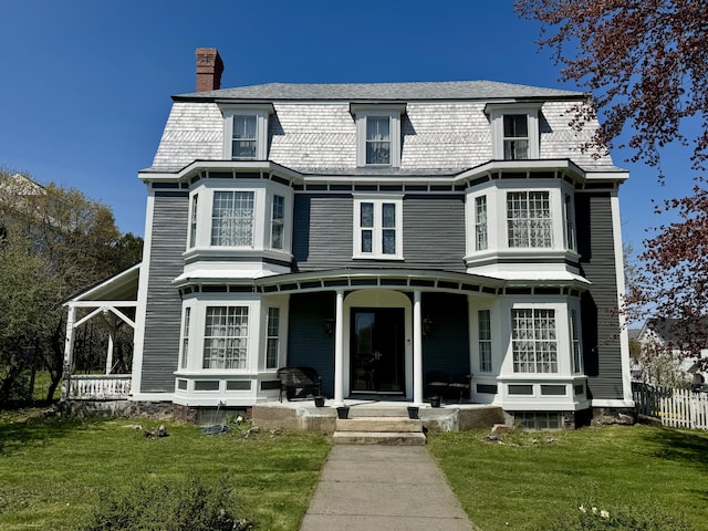 17 Boynton St, Eastport, ME 04631 - view of front of house with a porch, a chimney, and a front lawn