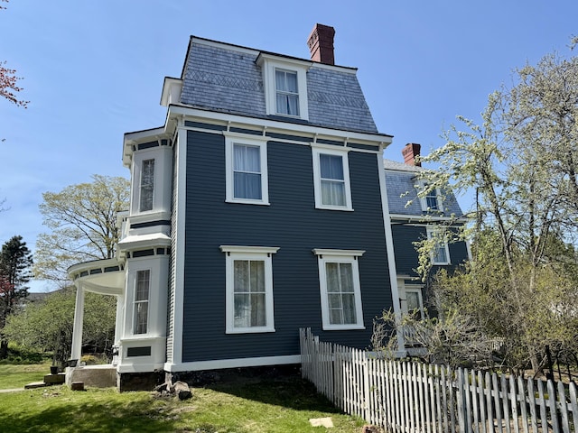 17 Boynton St, Eastport, ME 04631 - back of house featuring a chimney, a high end roof, and mansard roof