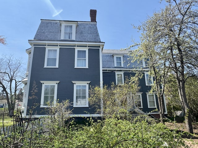 17 Boynton St, Eastport, ME 04631 - back of property with mansard roof, a high end roof, and a chimney