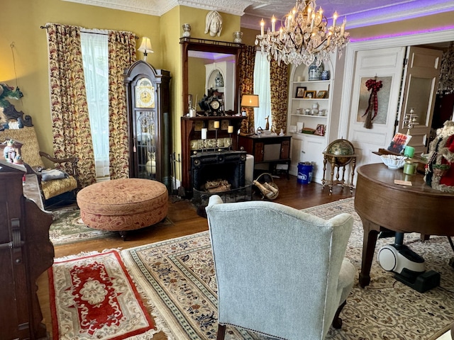 17 Boynton St, Eastport, ME 04631 - living area featuring wood finished floors, a chandelier, ornamental molding, a fireplace, and built in features