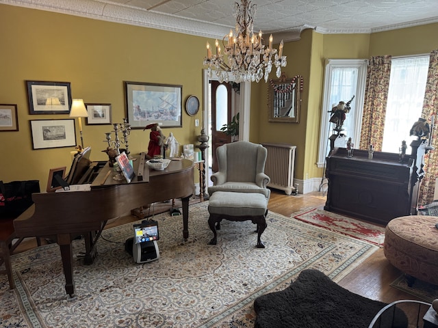 17 Boynton St, Eastport, ME 04631 - home office with radiator, a chandelier, wood finished floors, ornamental molding, and baseboards