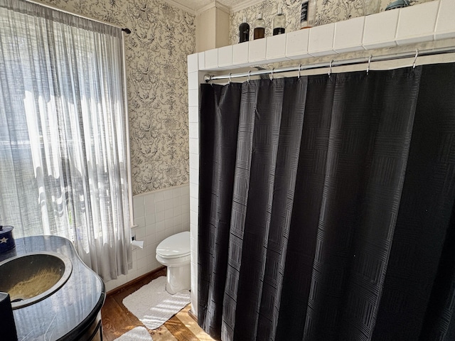 17 Boynton St, Eastport, ME 04631 - bathroom featuring wallpapered walls, toilet, wainscoting, wood finished floors, and ornamental molding