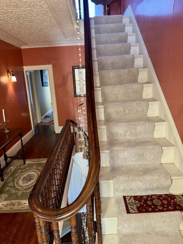 17 Boynton St, Eastport, ME 04631 - stairs with wood finished floors, baseboards, and ornamental molding