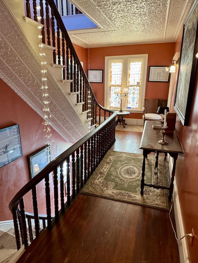 17 Boynton St, Eastport, ME 04631 - stairs with hardwood / wood-style flooring, baseboards, and crown molding