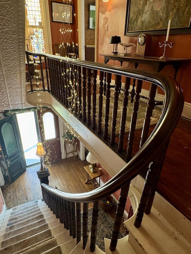 17 Boynton St, Eastport, ME 04631 - staircase featuring wood-type flooring, a chandelier, and healthy amount of natural light
