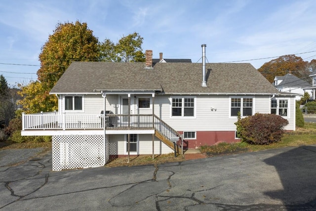 47 Atlantic Ave, Boothbay Harbor, ME 04538 - rear view of house with roof with shingles and a chimney