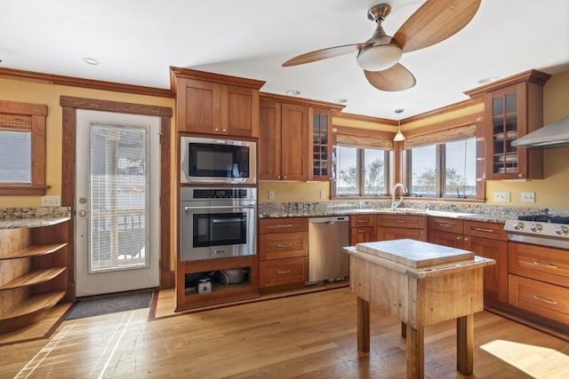 47 Atlantic Ave, Boothbay Harbor, ME 04538 - kitchen featuring light wood-style floors, ceiling fan, stainless steel appliances, and brown cabinets