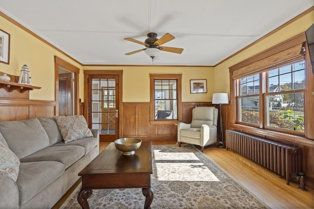 47 Atlantic Ave, Boothbay Harbor, ME 04538 - living room with radiator heating unit, a wainscoted wall, plenty of natural light, and wood finished floors