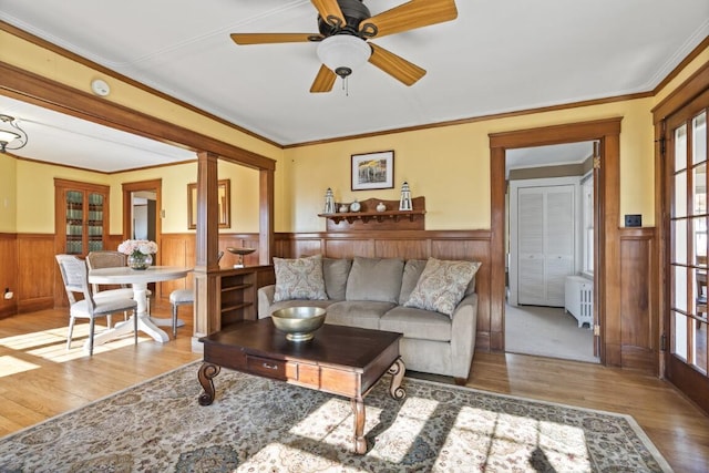 47 Atlantic Ave, Boothbay Harbor, ME 04538 - living area with ornamental molding, wood finished floors, radiator heating unit, a wainscoted wall, and a ceiling fan