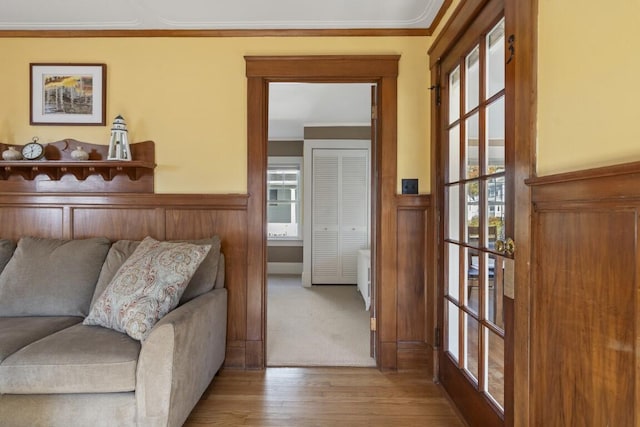 47 Atlantic Ave, Boothbay Harbor, ME 04538 - living area featuring ornamental molding, wood finished floors, and a wainscoted wall