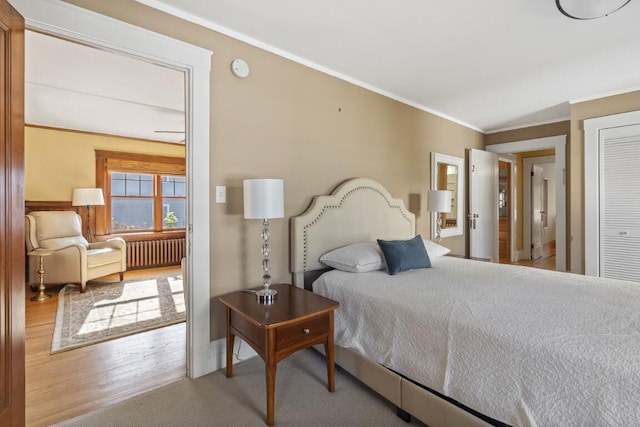 47 Atlantic Ave, Boothbay Harbor, ME 04538 - bedroom with radiator heating unit, baseboards, wood finished floors, ornamental molding, and a closet