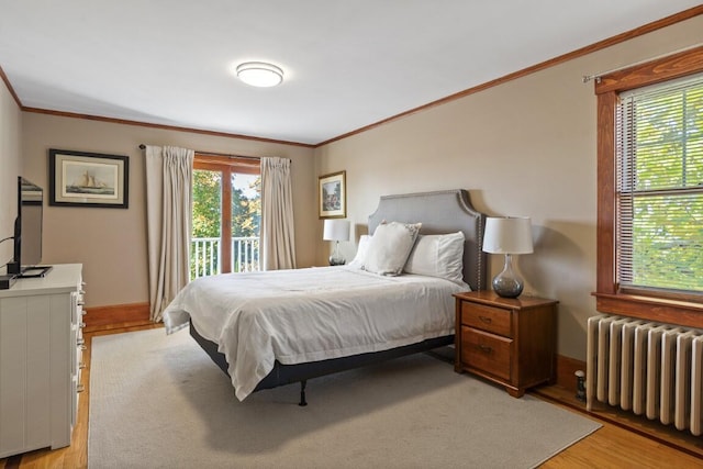 47 Atlantic Ave, Boothbay Harbor, ME 04538 - bedroom with radiator, ornamental molding, light wood-type flooring, and access to exterior