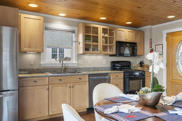 47 Atlantic Ave, Boothbay Harbor, ME 04538 - kitchen featuring dark wood finished floors, a sink, black appliances, glass insert cabinets, and light brown cabinets