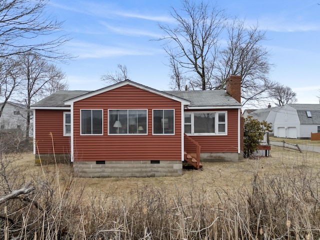 rear view of property featuring a chimney, a shingled roof, crawl space, and entry steps