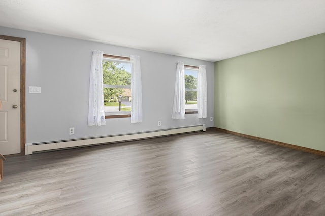 84 Old Carriage Rd Unit 84, Auburn, ME 04210 - empty room with baseboard heating and wood finished floors