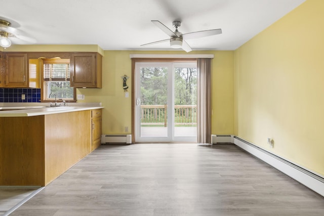 84 Old Carriage Rd Unit 84, Auburn, ME 04210 - kitchen featuring baseboard heating, ceiling fan, and healthy amount of natural light