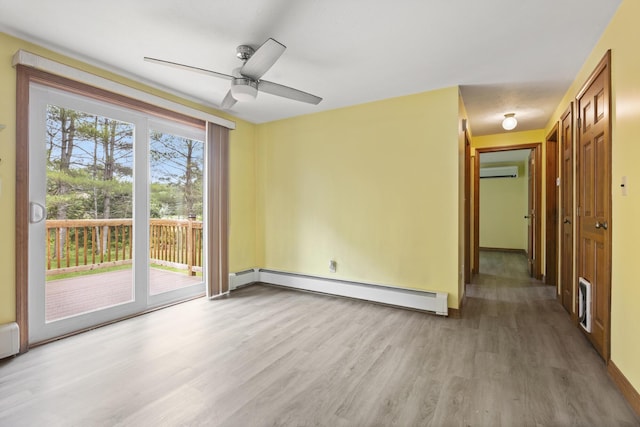 84 Old Carriage Rd Unit 84, Auburn, ME 04210 - empty room with a baseboard radiator, a wall unit AC, light wood-style floors, and a ceiling fan