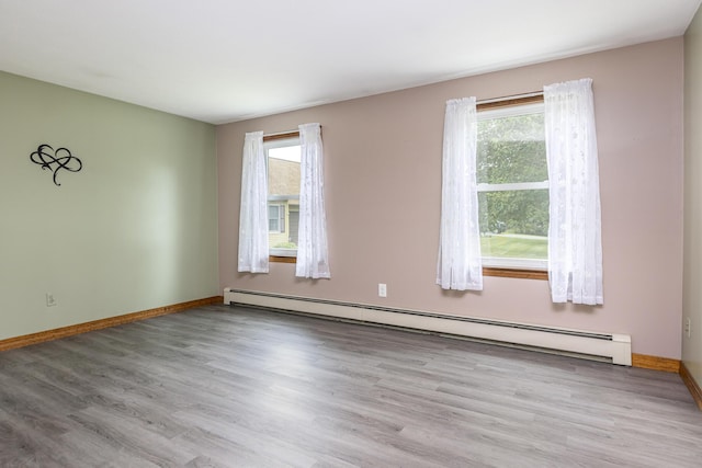 84 Old Carriage Rd Unit 84, Auburn, ME 04210 - unfurnished room with a baseboard heating unit and wood finished floors