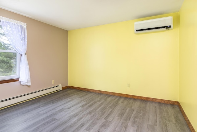 84 Old Carriage Rd Unit 84, Auburn, ME 04210 - empty room featuring an AC wall unit, wood finished floors, and a baseboard radiator