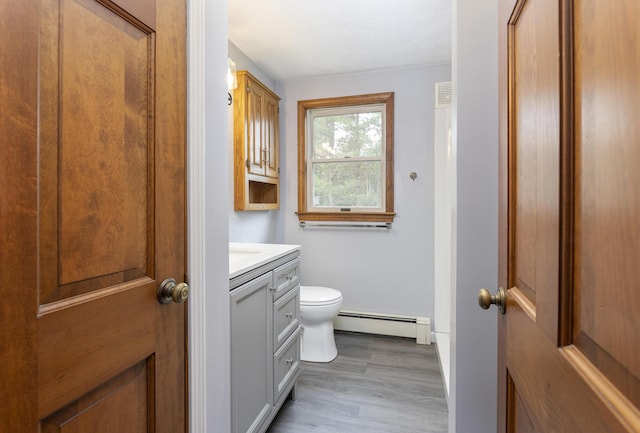 84 Old Carriage Rd Unit 84, Auburn, ME 04210 - bathroom featuring a baseboard radiator, vanity, and wood finished floors
