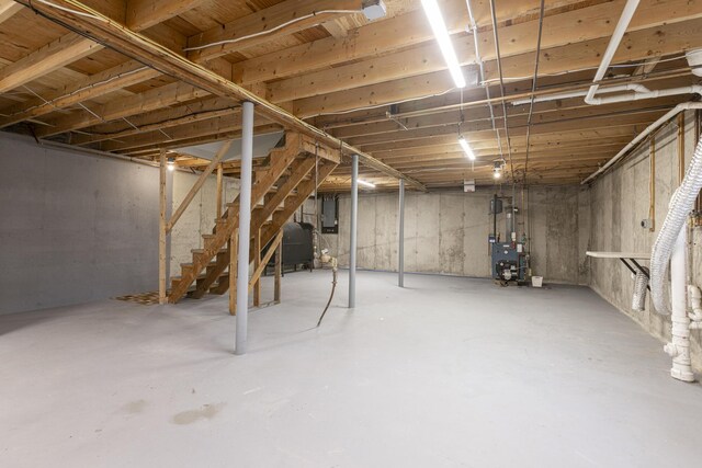 84 Old Carriage Rd Unit 84, Auburn, ME 04210 - unfinished below grade area featuring electric panel, stairs, heating fuel, and a heating unit