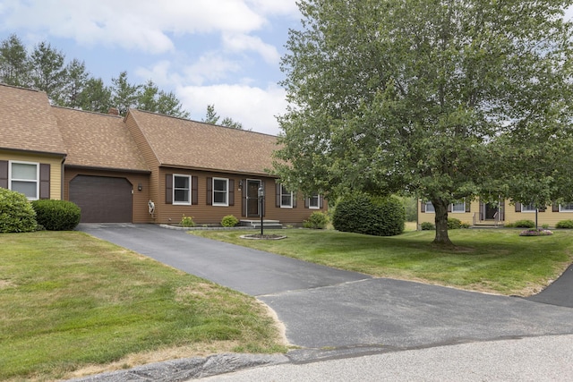 84 Old Carriage Rd Unit 84, Auburn, ME 04210 - view of front of house featuring a garage, driveway, roof with shingles, and a front lawn