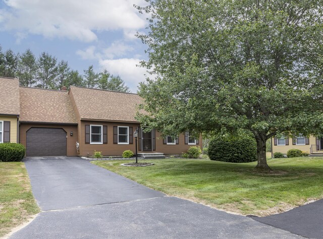 84 Old Carriage Rd Unit 84, Auburn, ME 04210 - view of front of house with driveway, a garage, a shingled roof, and a front lawn