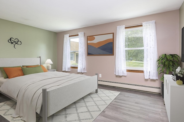 84 Old Carriage Rd Unit 84, Auburn, ME 04210 - bedroom featuring a baseboard heating unit and wood finished floors