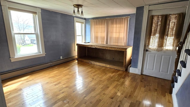 394 Linnell St, Rumford, ME 04276 - empty room with a baseboard radiator and wood-type flooring