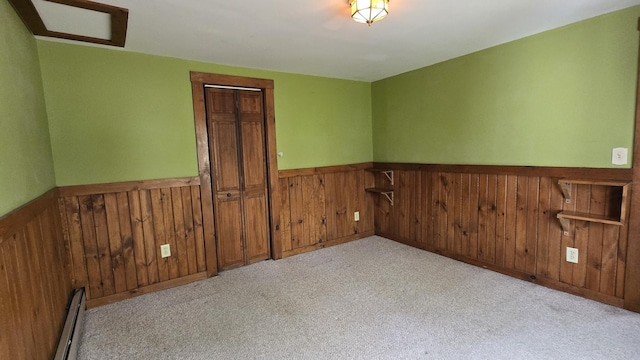 394 Linnell St, Rumford, ME 04276 - unfurnished room with a wainscoted wall, carpet, and a baseboard heating unit