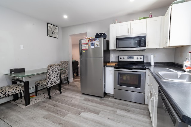 867 Minot Ave, Auburn, ME 04210 - kitchen with stainless steel appliances, white cabinetry, light wood-style flooring, dark countertops, and recessed lighting