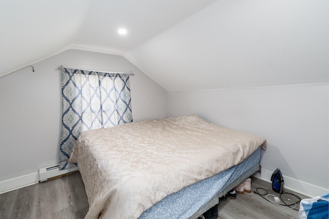 867 Minot Ave, Auburn, ME 04210 - bedroom with wood finished floors, vaulted ceiling, and a baseboard radiator