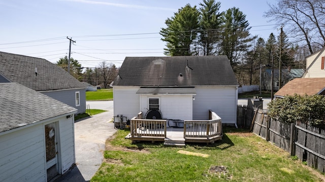 867 Minot Ave, Auburn, ME 04210 - back of property with a deck, a detached garage, and roof with shingles