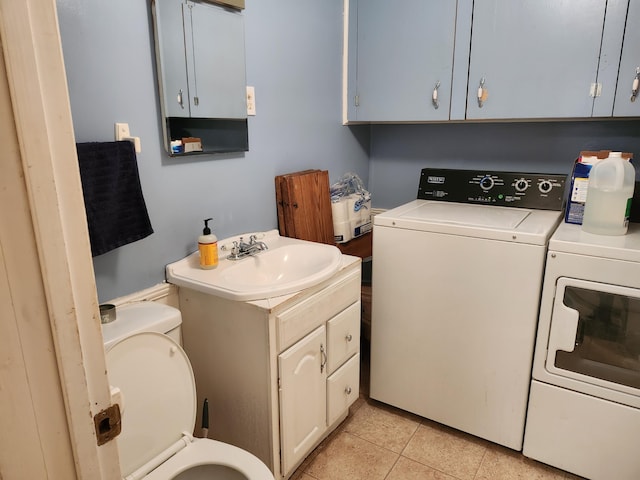 53 Village Rd, Stetson, ME 04488 - washroom with washing machine and clothes dryer and light tile patterned floors